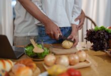 CoupleCuttingPotatoesToCookOrMakeSaladInHome