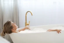 Žena relaxuje v napěněné vaně.