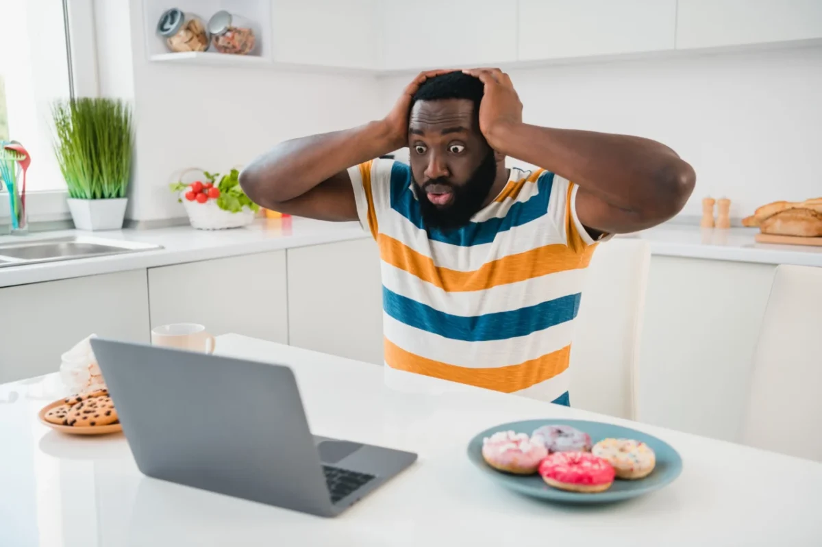 Muž šokovaně zírá do notebooku.