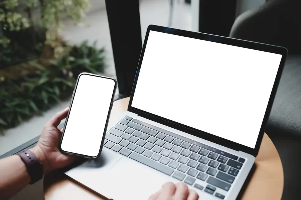 shutterstock_2366798175_769255514330 | TVGURU.cz Mobilní telefon a notebook na stole