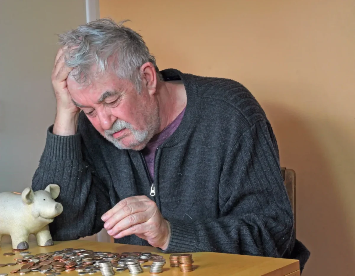 Starý muž počítá peníze.