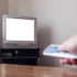 Muž zapínající starou televizi