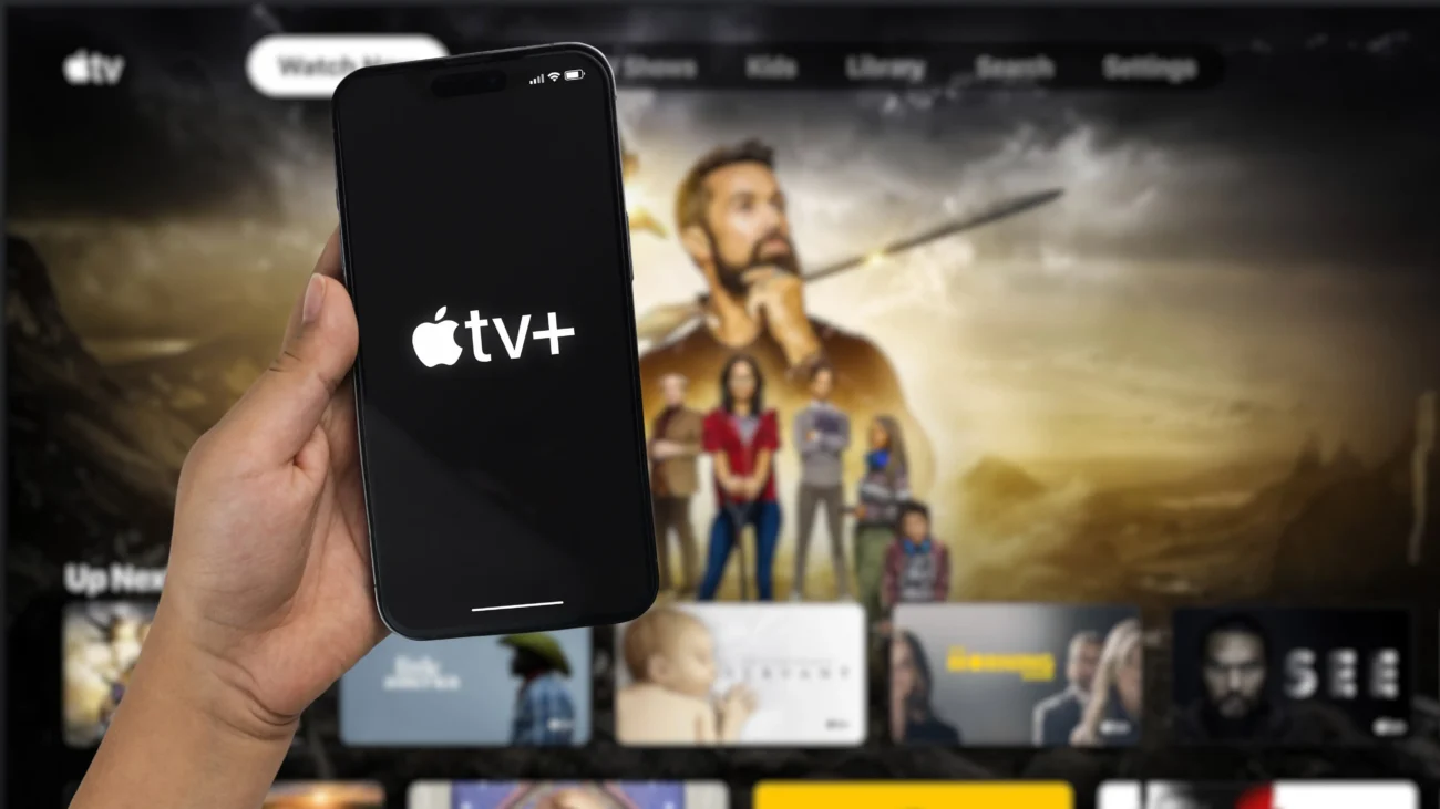 shutterstock_2246538411-2 | TVGURU.cz Člověk má Apple TV zapnutou na mobilu i televizi.