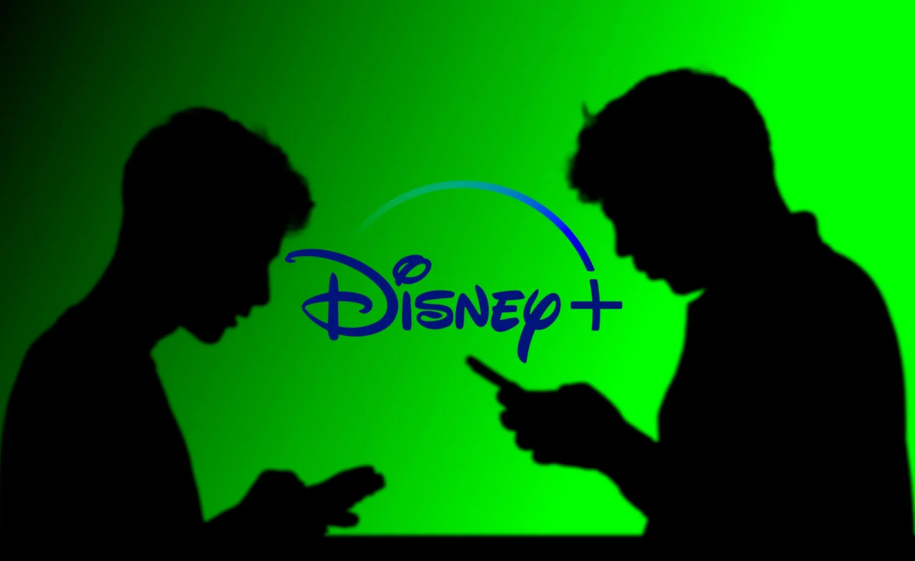 shutterstock_2484499613-2 | TVGURU.cz Muži stojí před nápisem Disney+.
