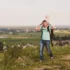 Muž s miminkem se prochází přírodou.