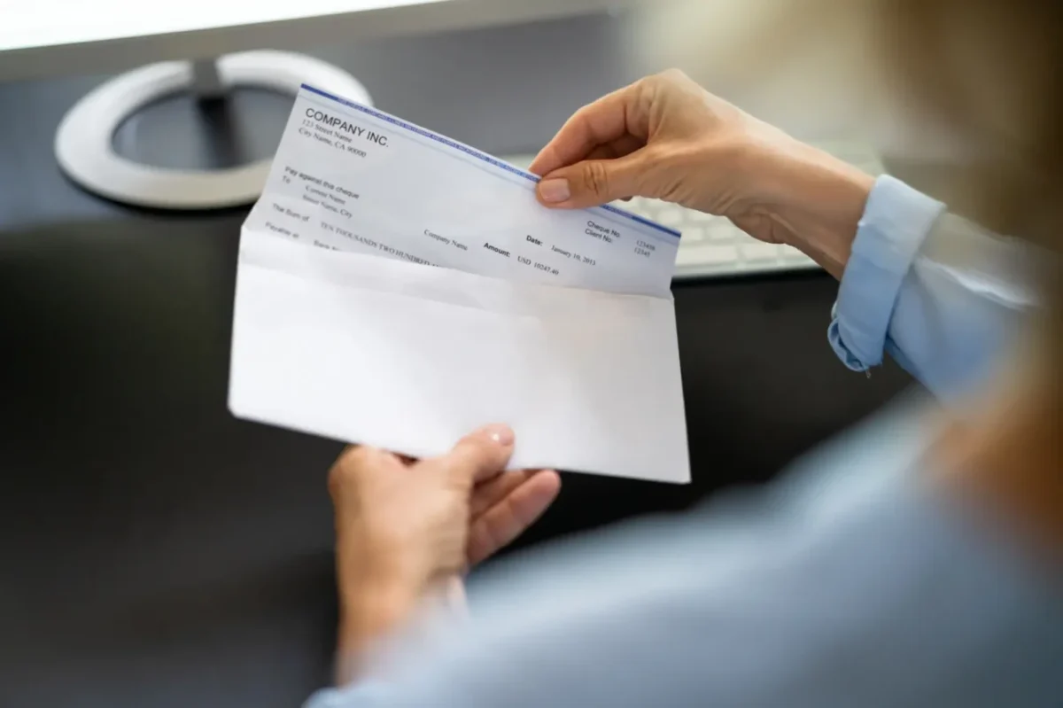 osoba drží obálku s výplatní páskou