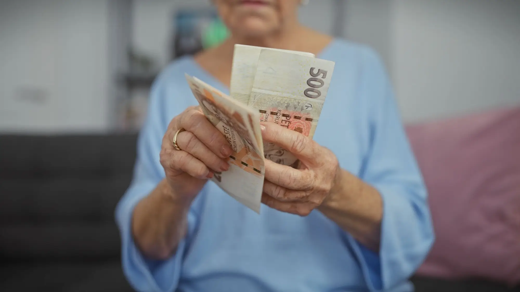 Shutterstock_2467785943 | TVGURU.cz stará žena počítá české bankovky