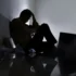 Zdrcený muž sedí na zemi a drží si hlavu.