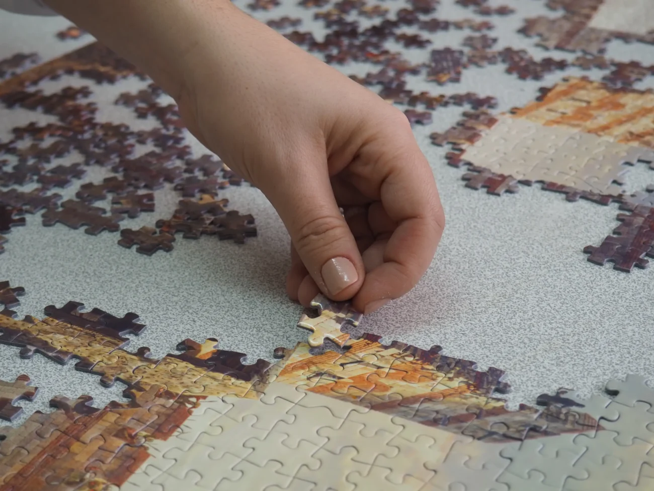 Člověk skládá puzzle.