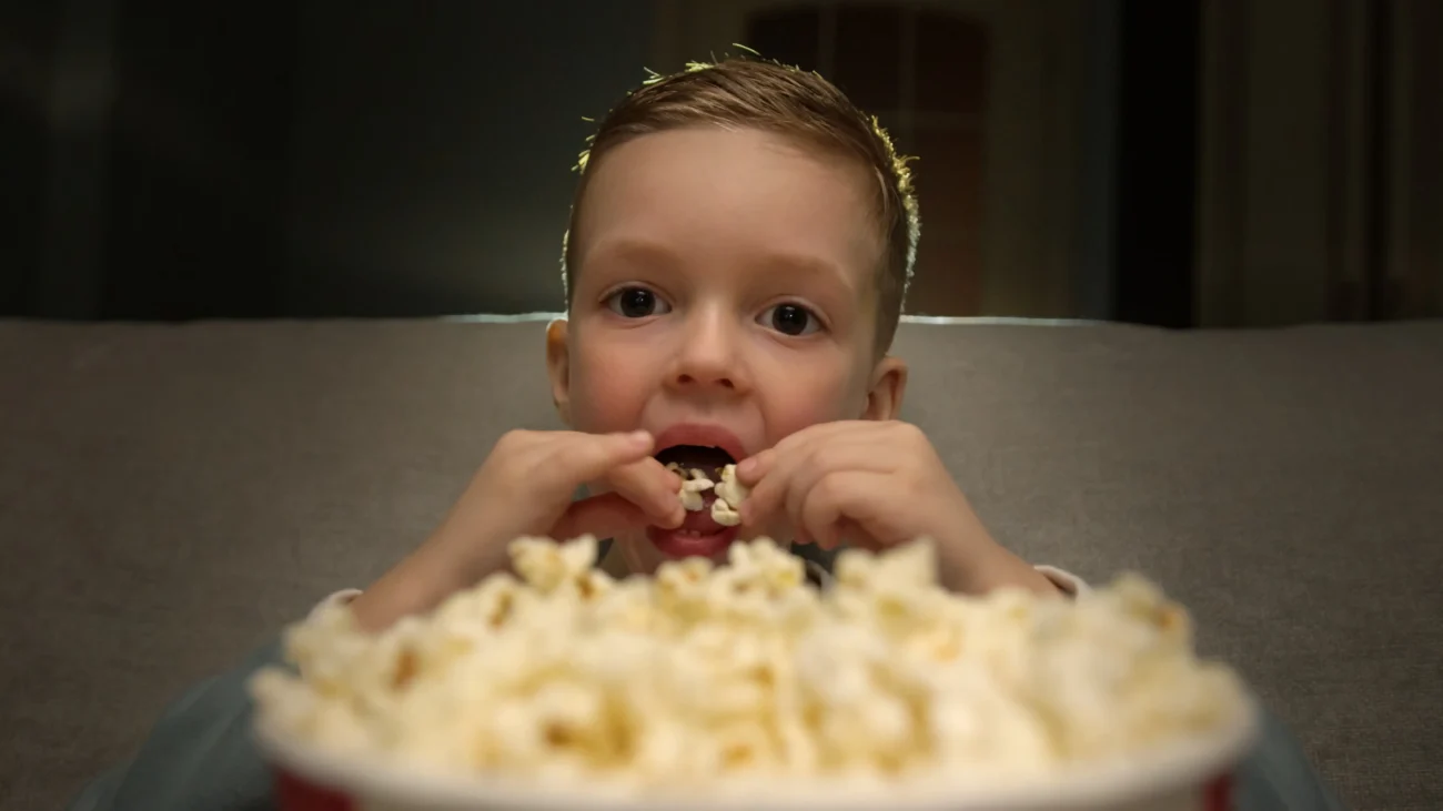 shutterstock_2341618793-2 | TVGURU.cz Chlapeček jí popcorn.