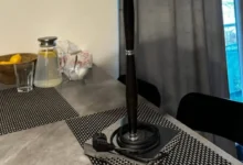 stůl v kuchyni, leží na něm lampa s elektrickou zásuvkou