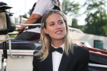 Emma Smetana stojí před autem a usmívá se.