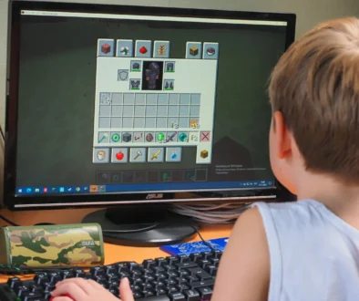 Chlapeček sedí u Minecraftu.