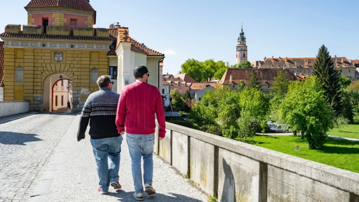 Muži se procházejí u zámku.