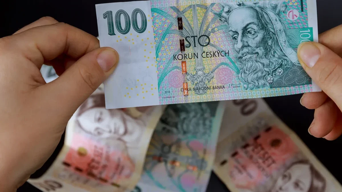 žena drží v ruce peníze