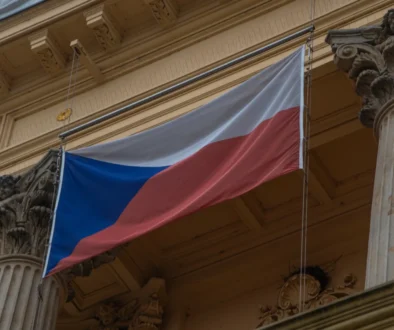 Na budově visí česká vlajka.