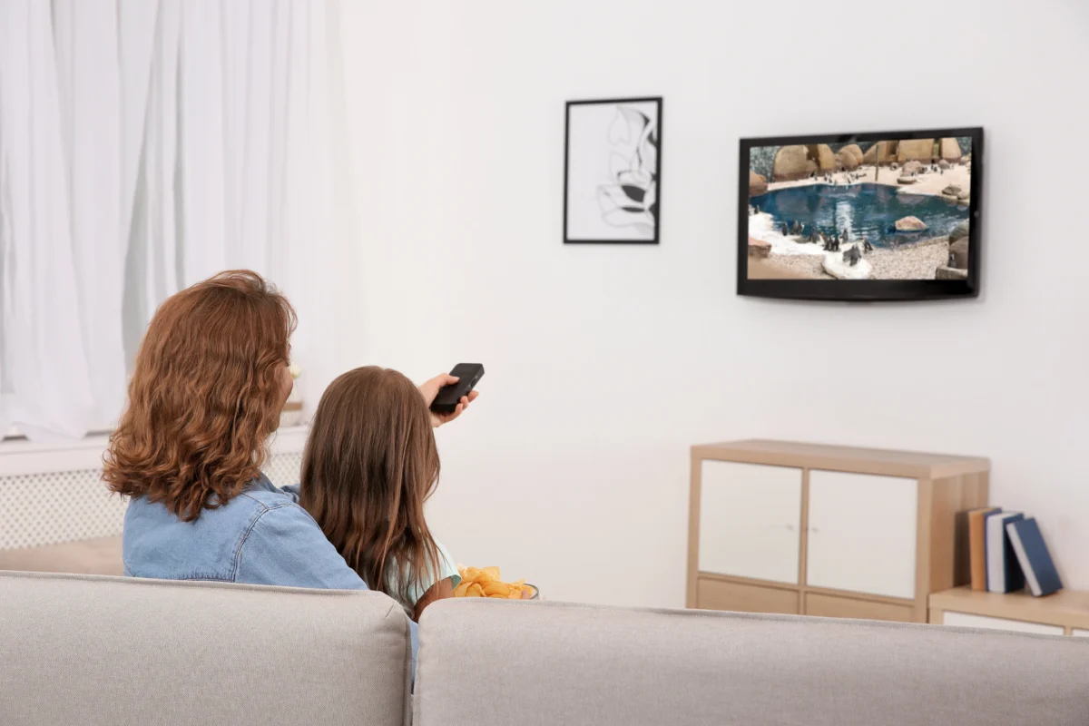 matka s dcerou sledují TV