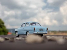 Staré auto jede po cestě.