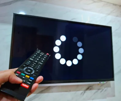 Člověk ovladačem míří na TV.