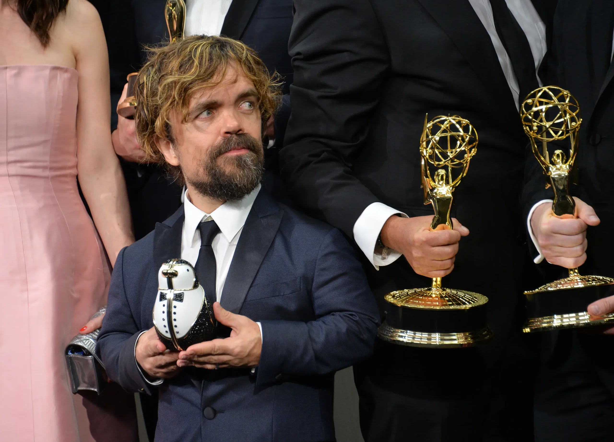 Peter Dinklage v ruce drží cenu.