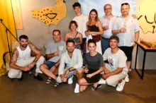 lidé u zdi pózují na fotku