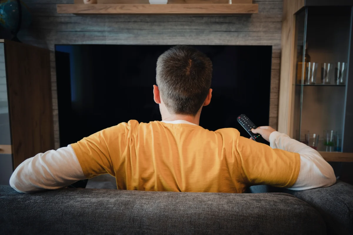 muž sleduje televizi