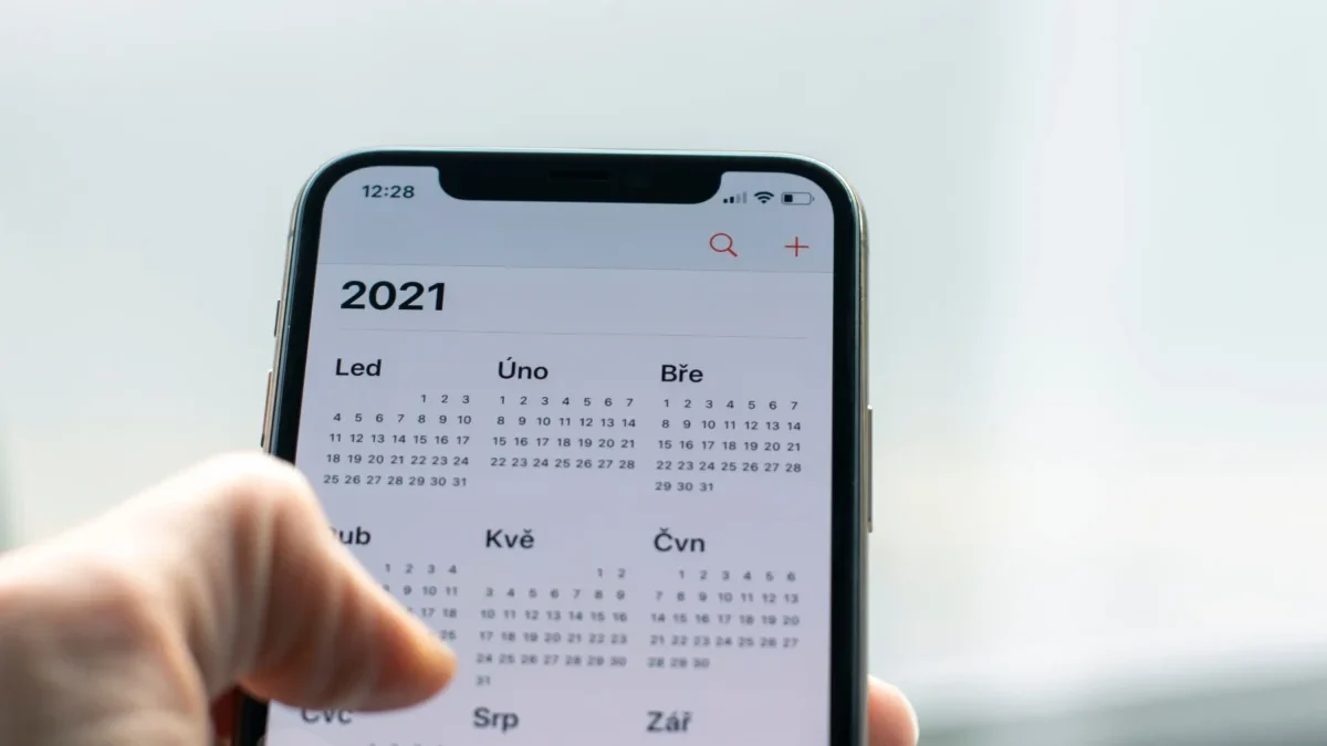 Člověk má v telefonu otevřený kalendář.