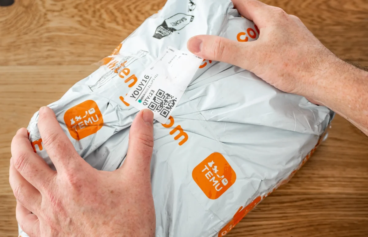 Člověk se chystá rozbalit Temu balíček.