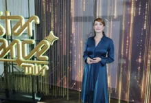 Tereza Kostková stojí vedle nápisu.