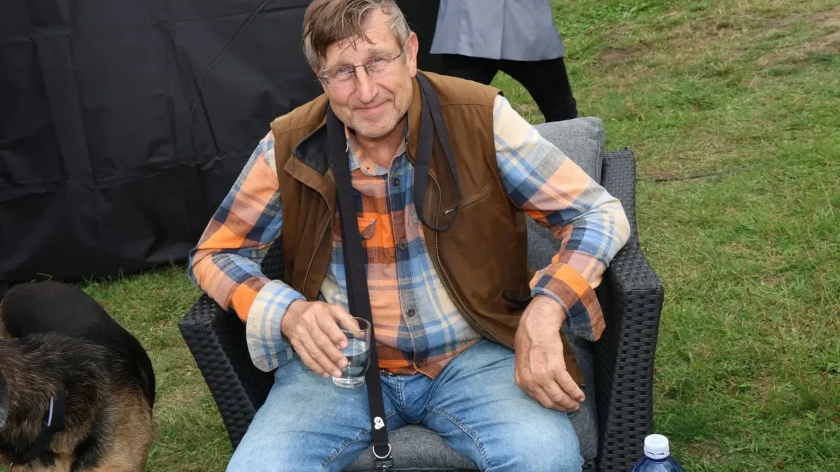 Václav Vydra sedí venku na židli.