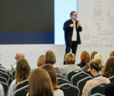 Muž mluví na konferenci.