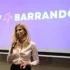 žena s mikrofonem stojí před plátnem