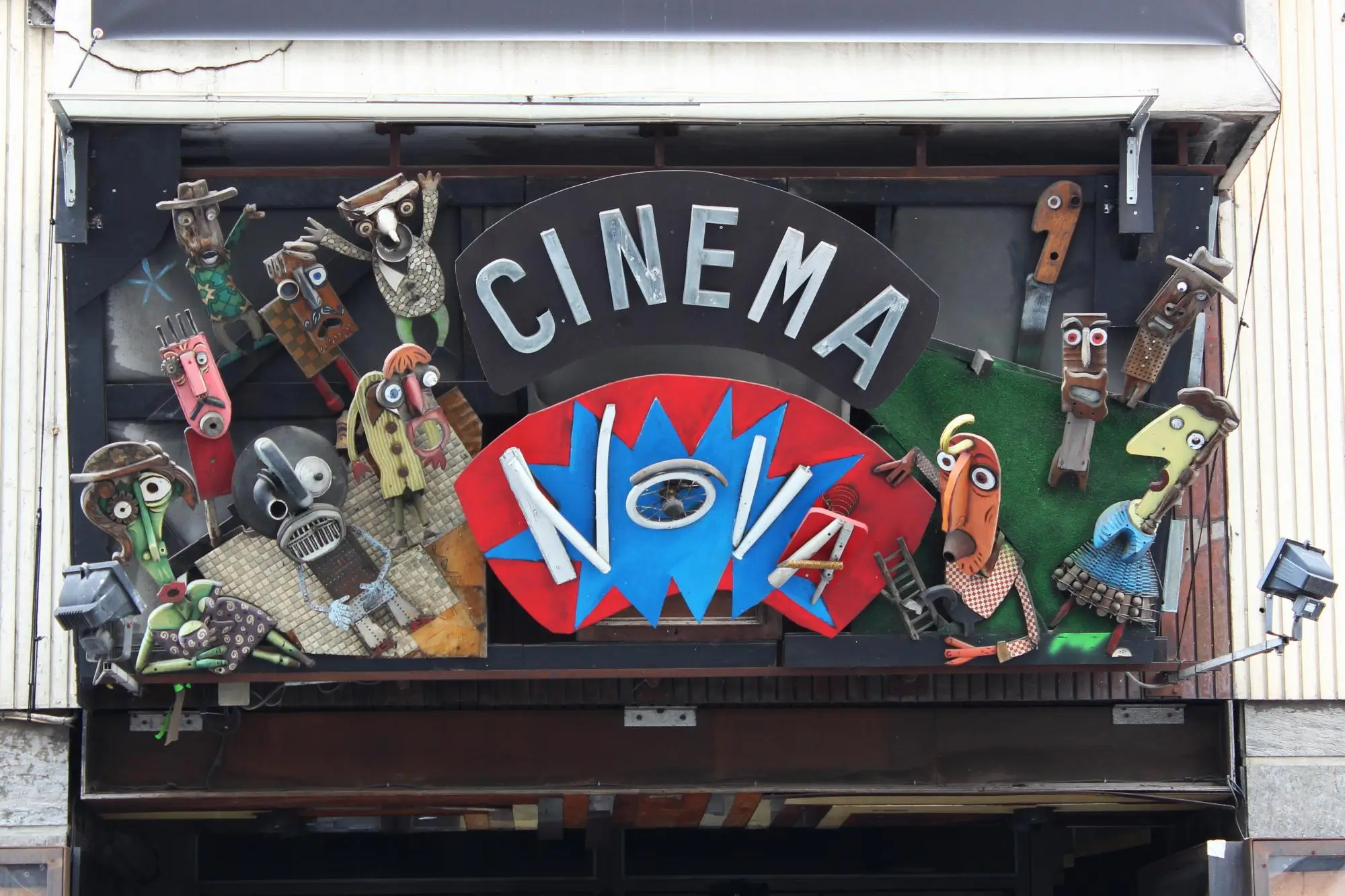 Nova Cinema přináší nedělní dobrodružství | TVGURU.cz Colorful, whimsical puppet sculptures and masks surround a storefront sign that reads CINEMA, creating a playful exterior display.