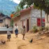 Dusty village street with women and children walking past simple brick houses; a rooster in the foreground.