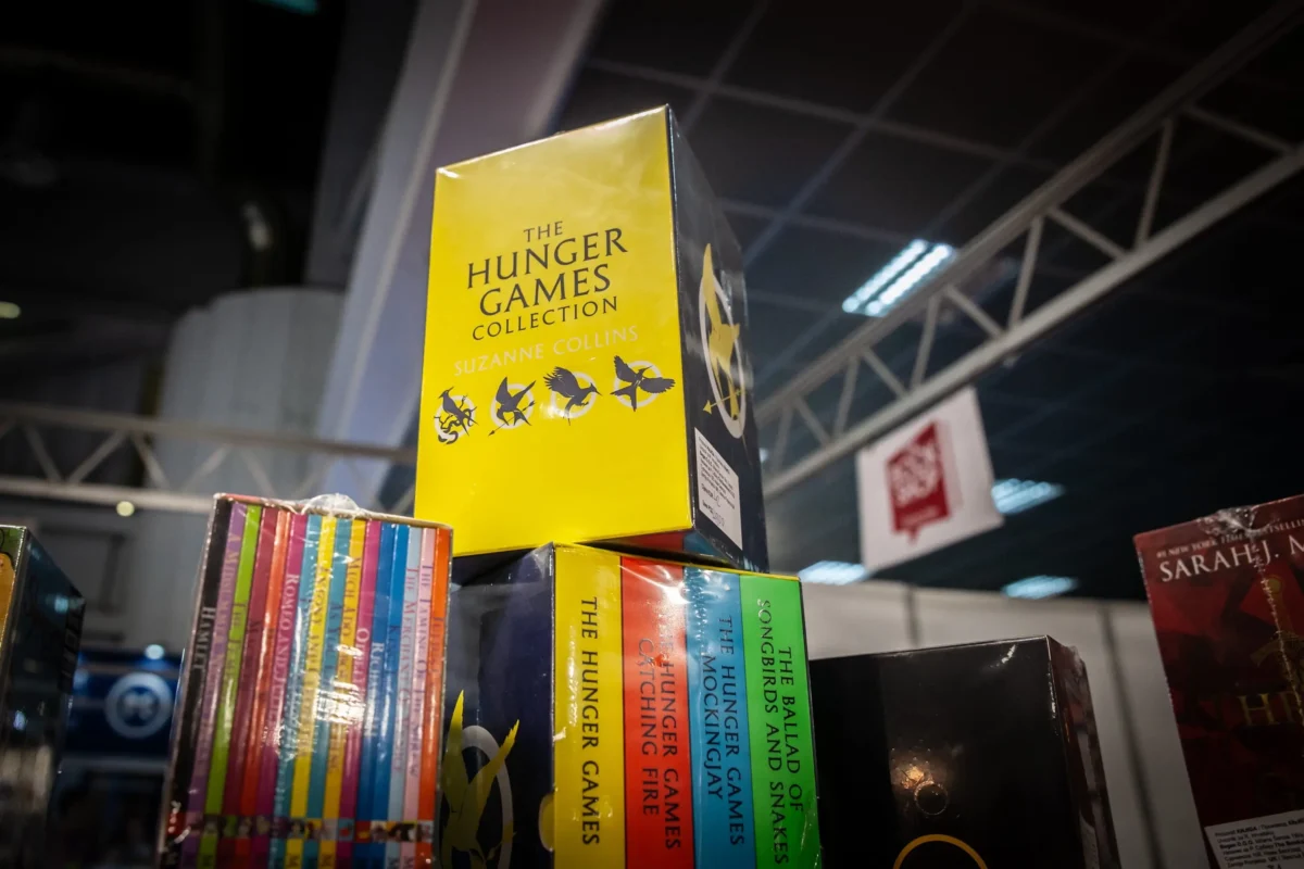 Yellow Hunger Games collection box on a store shelf with colorful book spines underneath.