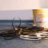 Coiled strips of movie film spread across a carpet with a yellow popcorn bucket in the background.