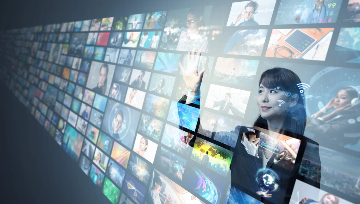 shutterstock_1405194656 1 | TVGURU.cz Businesswoman touching a wall of digital thumbnails and data panels on a holographic screen? interface.