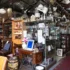 Antique shop interior filled with glass cabinets, chandeliers, vases, and wooden furniture