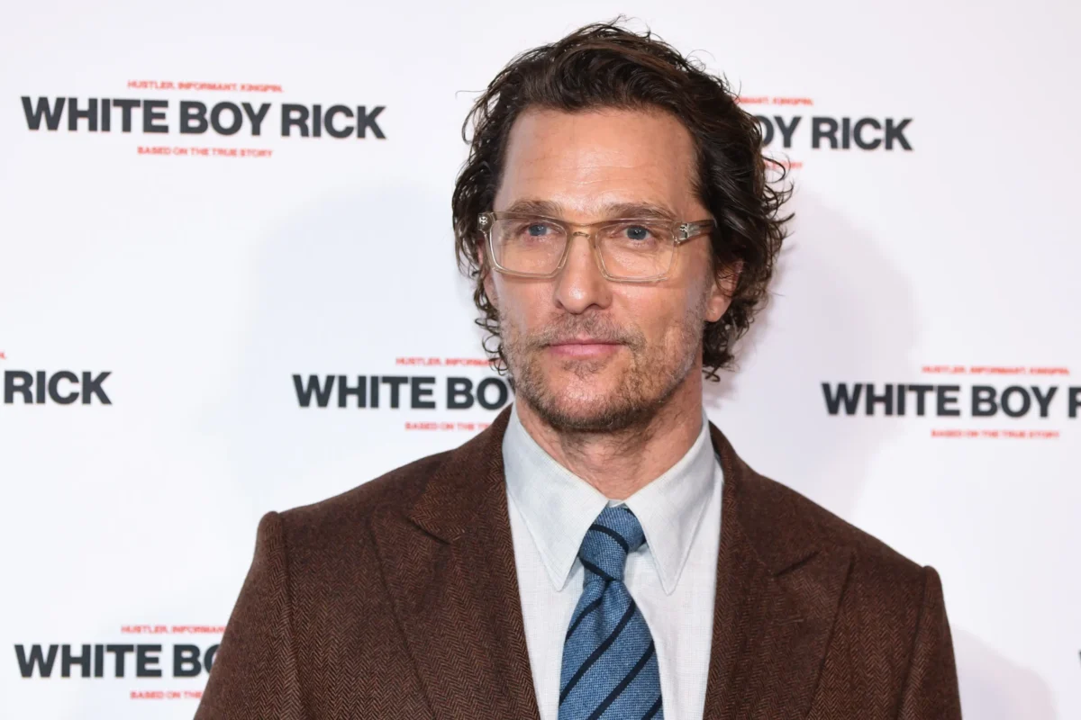 Matthew McConaughey s brýlemi s čirým rámem, hnědým sakem a modrou pruhovanou kravatou pózuje na premiéře White Boy Rick.