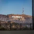 Hollywood sign on a hill seen through a window with black vertical bars in the foreground.