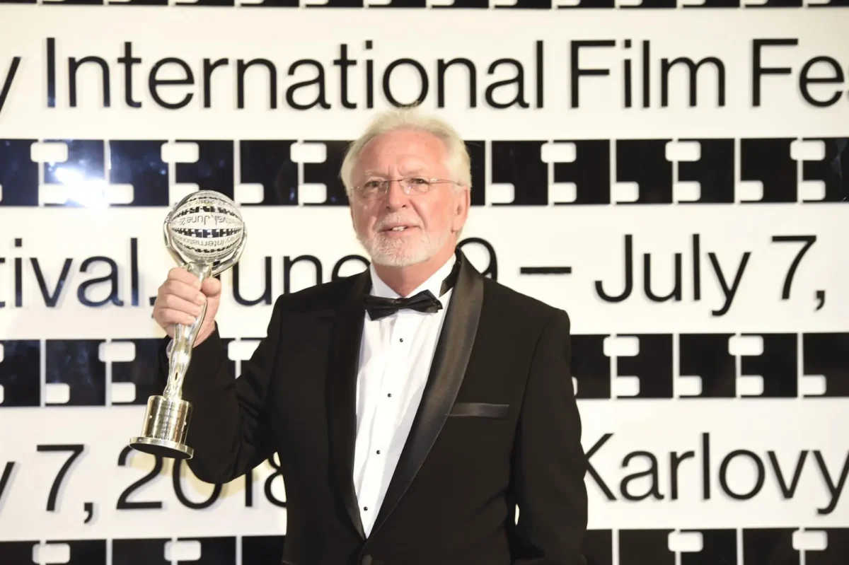 KVIFF 2018 - ocenění za přínos kinematografii | TVGURU.cz Muž v ruce drží cenu.