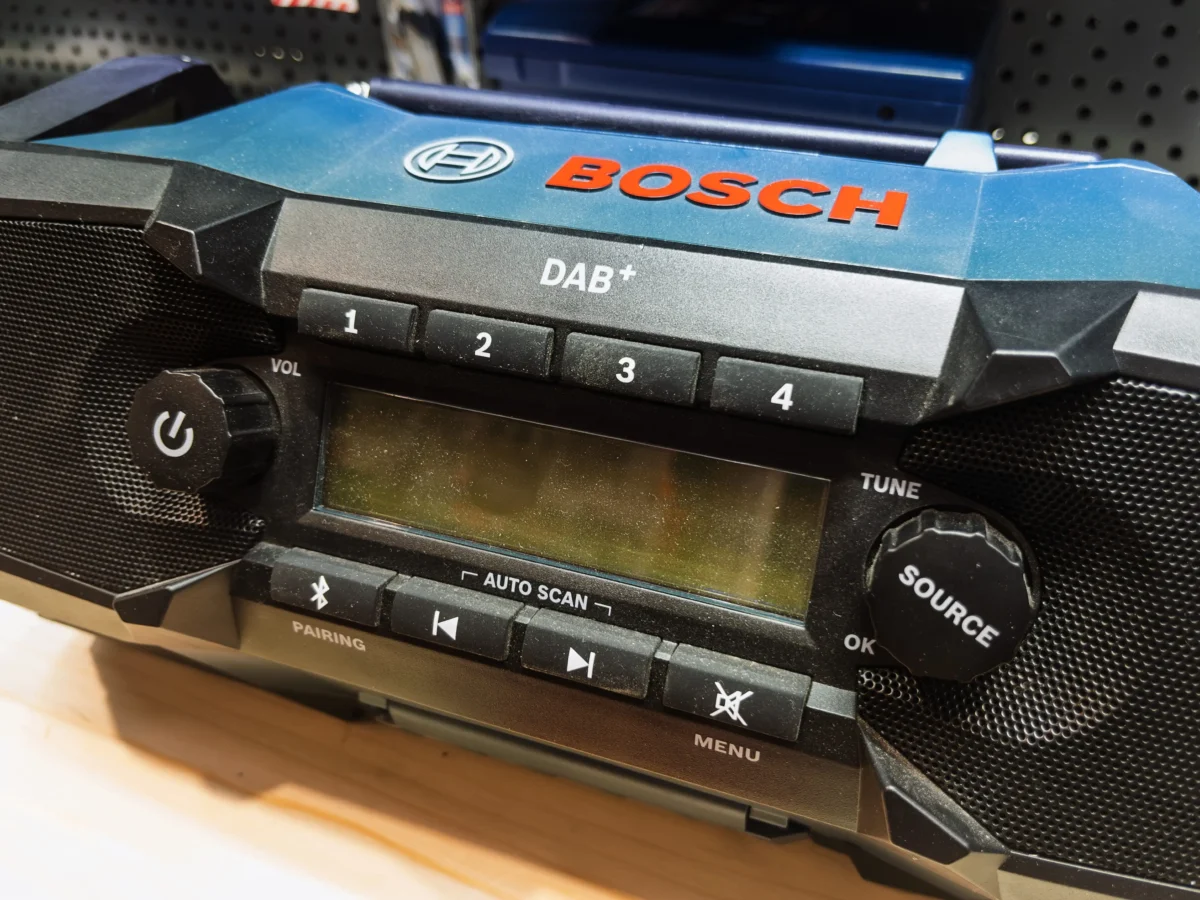 shutterstock_2602357219 1 | TVGURU.cz Close-up of a Bosch car stereo front panel showing DAB+ branding and numbered preset buttons 1–4.