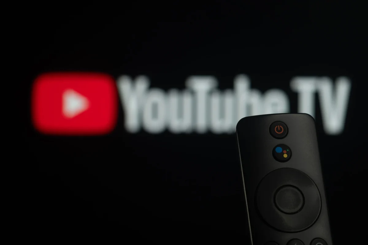 shutterstock_2729021897 1 | TVGURU.cz Blurred YouTube logo on screen with a streaming remote in the foreground.