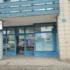 Blue-framed storefront of a Czech health insurance office (ZP 211) with glass doors and a street address plaque reading 1225 Wonkova on a beige tiled wall