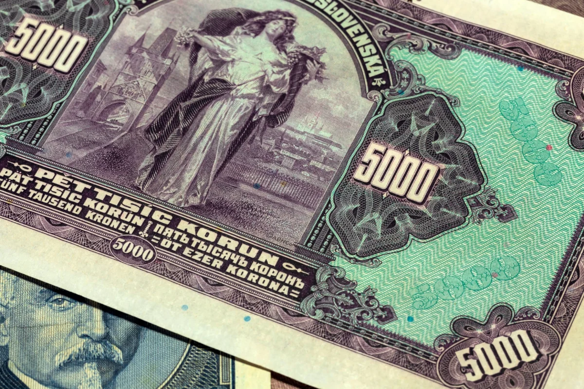 Pile of Russian banknotes with a prominent 5000 ruble denomination and Cyrillic inscriptions, showing ornate designs in purple and green tones