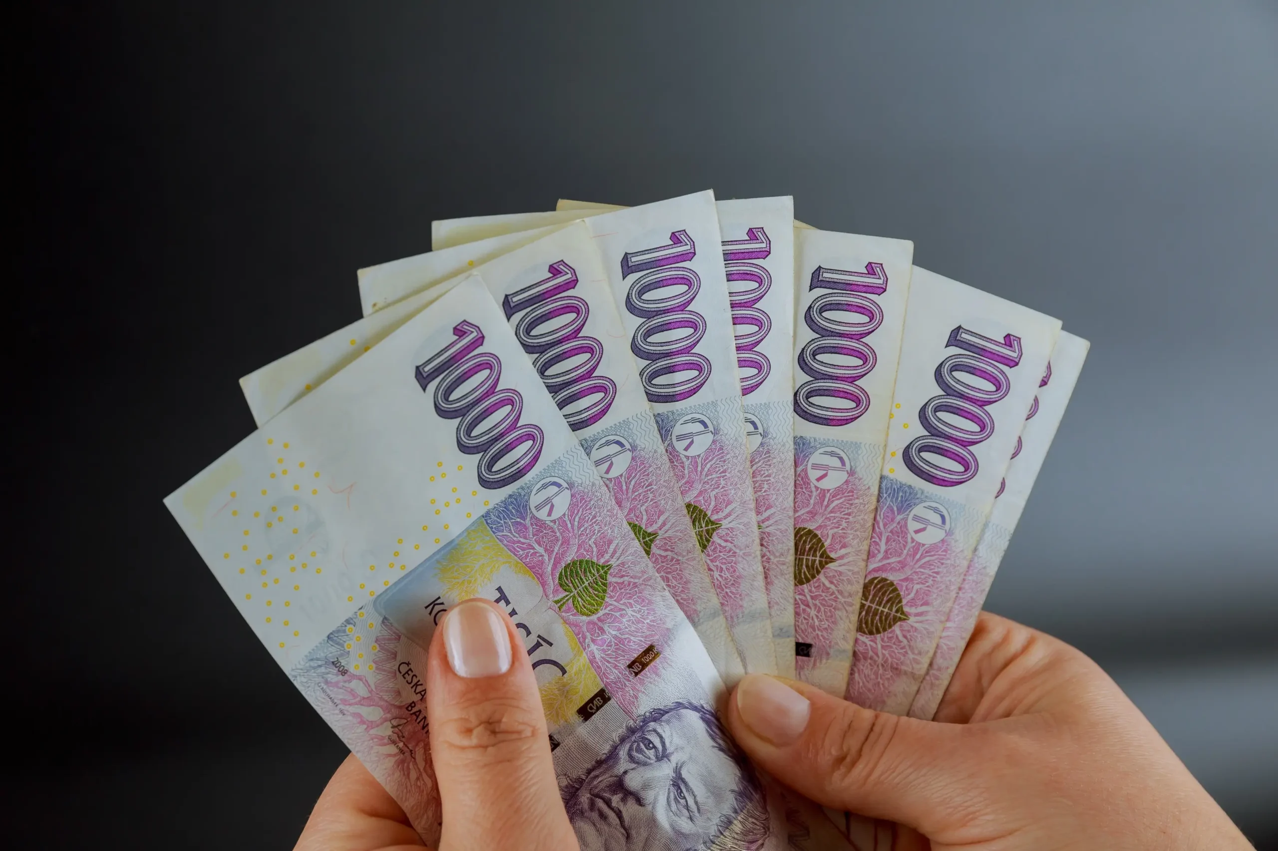 shutterstock_2206592421-2 | TVGURU.cz Osoba drží v ruce české bankovky