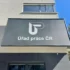 Signboard on a modern building reading 'Úřad práce ČR' with a white geometric logo on a dark panel.