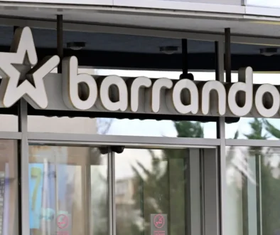 Storefront sign showing the word 'barandov' with a large star logo on the left, mounted above glass doors.