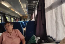 Seniorka sedí ve vlaku.