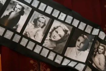 Fabric item featuring a film-strip design with black-and-white vintage Hollywood portraits of women.